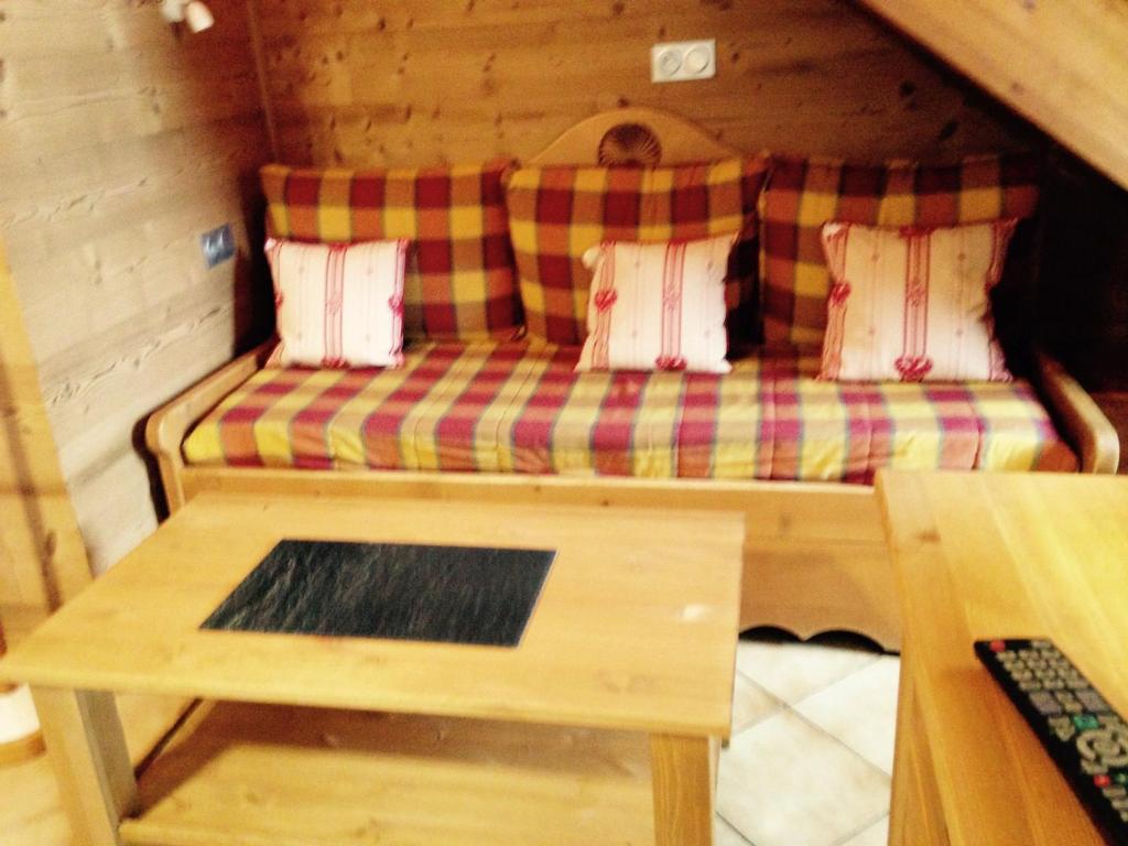 a couch sitting inside of a log cabin at Appartement Valloire, 4 pièces, 8 personnes - FR-1-263-178 in Valloire