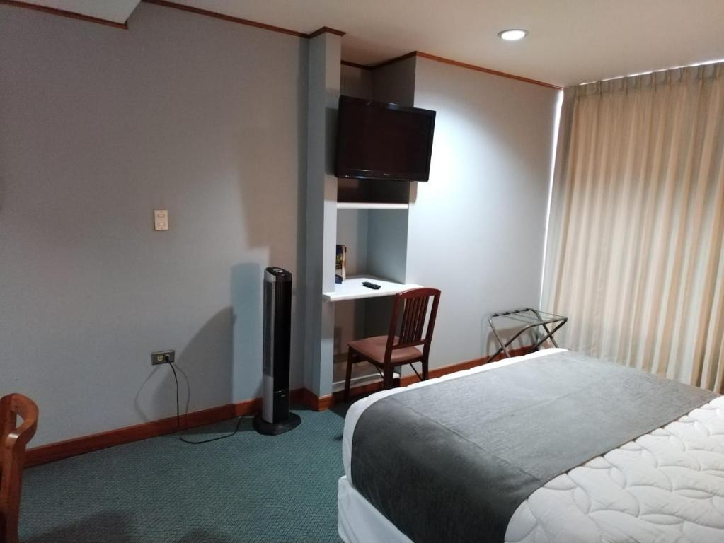 Postel nebo postele na pokoji v ubytování Apartotel Tairona