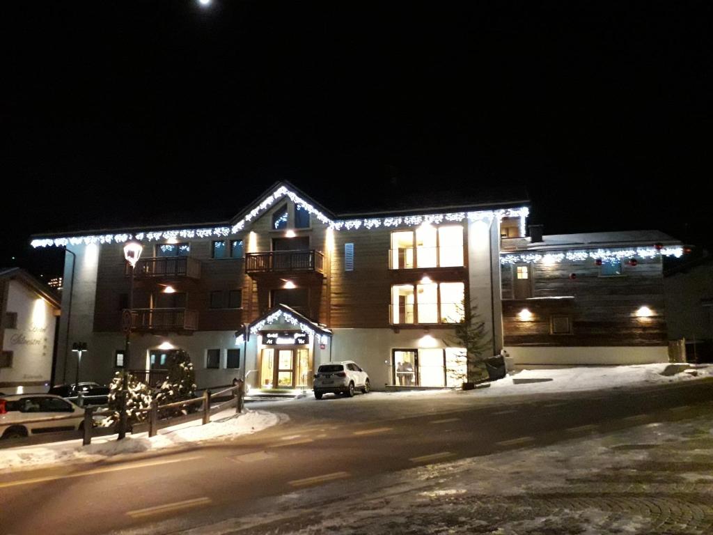 a building with christmas lights on it at night at Garni Al Silvestri Vei in Livigno