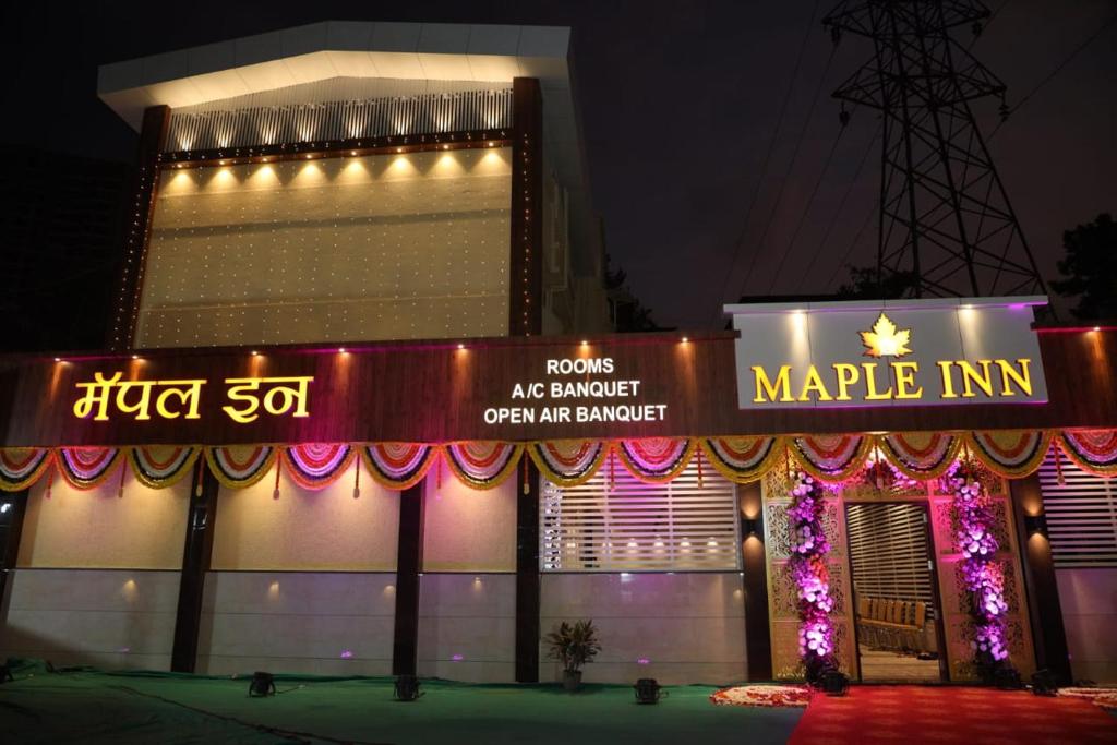 a building with a sign that reads market inn at Maple Inn in Thane