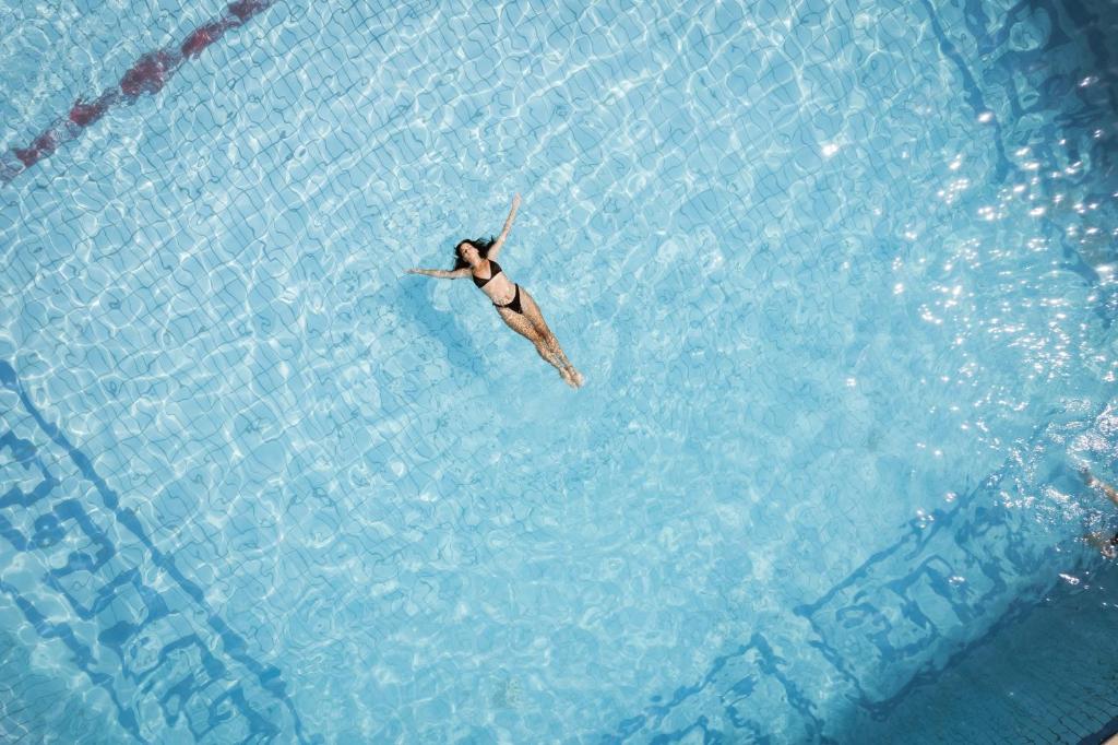 a person swimming in a pool of water at Atrium Hotel in Pefkochori