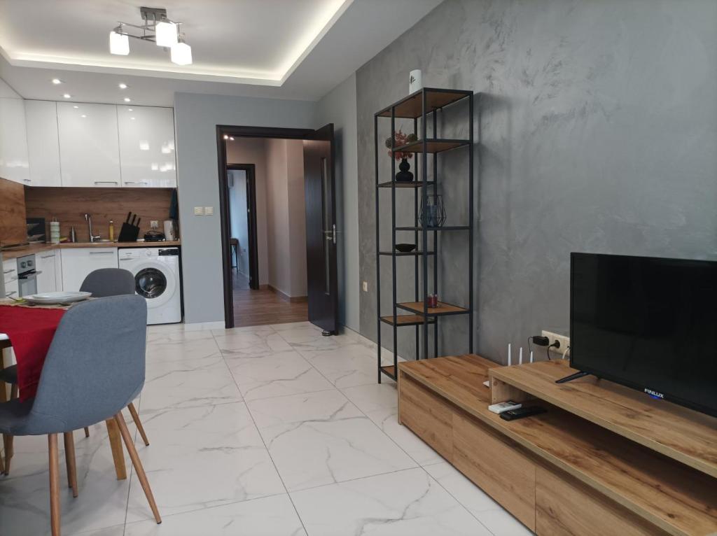a living room with a television and a table at One Bedroom Apartment 37- Trakia 54 А in Plovdiv