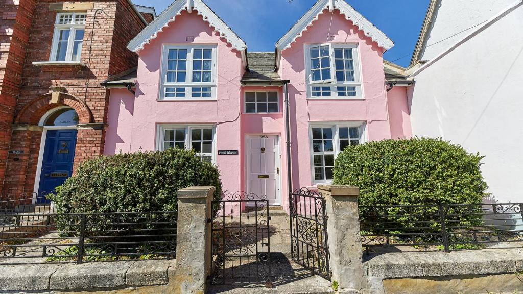 ein rosa Haus mit einem Tor davor in der Unterkunft The Pink House in Durham