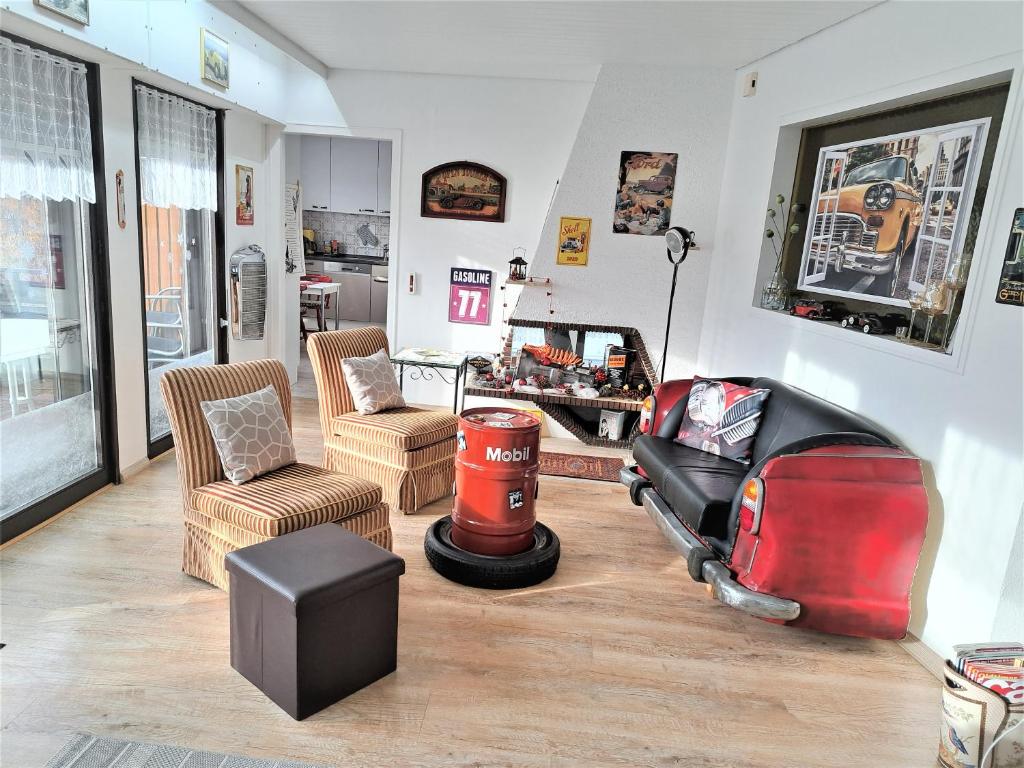 a living room with chairs and a motorcycle in it at Haus Schluchseeblick in Schluchsee