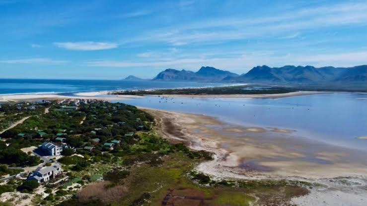 an aerial view of a beach and the ocean at Fisherhaven Guest House in Hermanus
