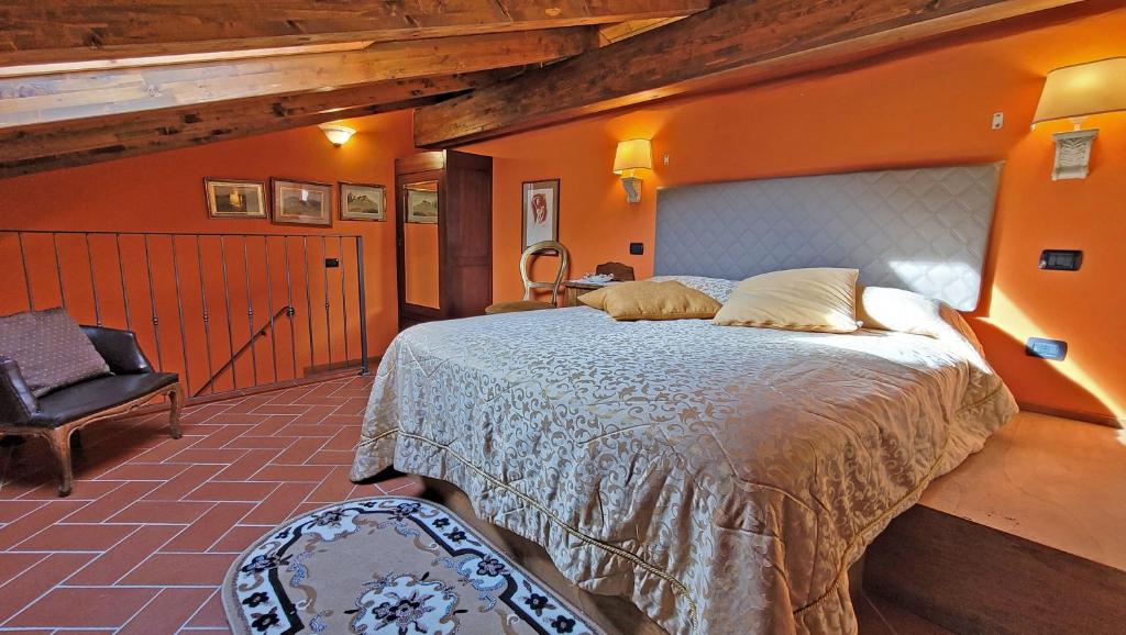sypialnia z dużym łóżkiem i krzesłem w obiekcie Locanda Le Panche w mieście Pistoia