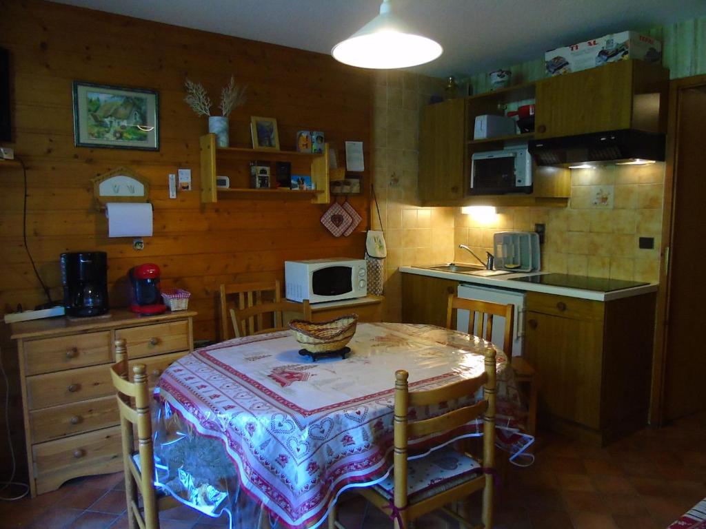 a kitchen with a table and a kitchen with a table and chairs at Appartement Châtel, 2 pièces, 4 personnes - FR-1-198-113 in Châtel