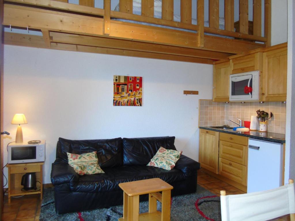 a living room with a couch and a kitchen at Appartement spacieux 6 personnes avec balcon à Châtel - FR-1-198-127 in Châtel