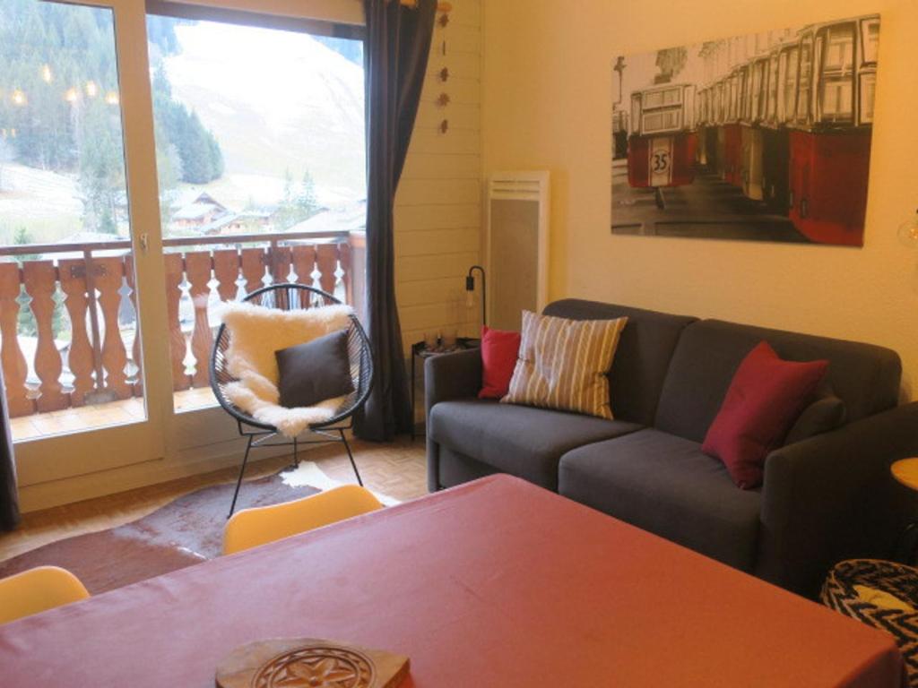 a living room with a couch and a table and a window at Appartement Châtel, 2 pièces, 5 personnes - FR-1-198-196 in Châtel