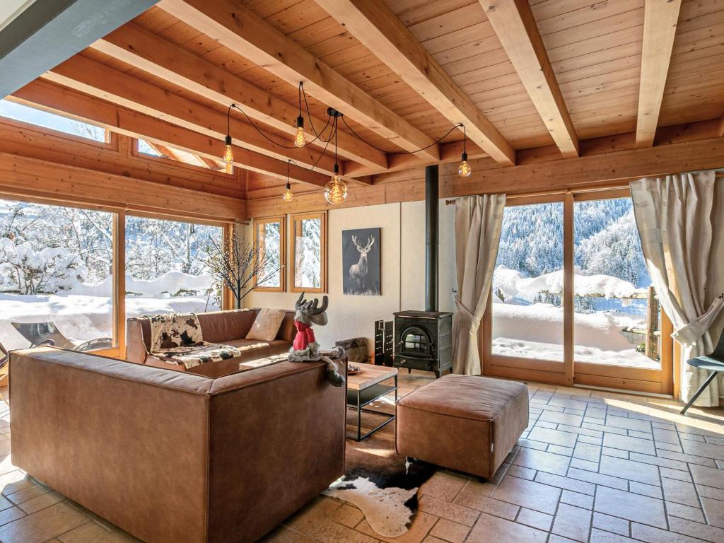 un salon avec un canapé et une cheminée dans l'établissement Chalet 4 Étoiles 13 Pers. à La Clusaz - Grande Terrasse, Garage, WIFI, Arrêt Skibus à Proximité - FR-1-437-81, à La Clusaz