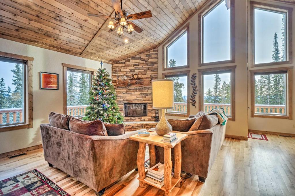 a living room with two couches and a christmas tree at 22STR-00367 Fairplay Cabin ~ 6 Mi to Downtown! in Fairplay