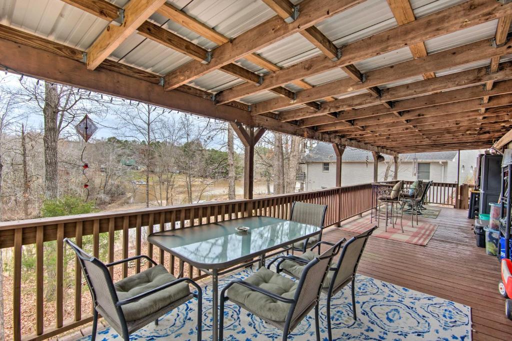 a patio with a glass table and chairs on a deck at Lake-View Getaway in Sherrills Ford with Deck! in Denver