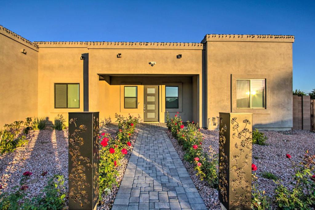 a house with flowers in front of it at Phoenix Home with Desert Views and Garden-Style Yard in Anthem