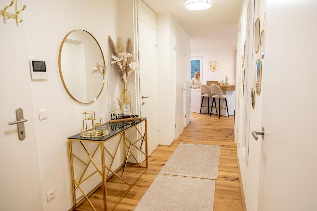 a hallway with a mirror and a table at Ferienwohnung Deluxe Sattendorf in Sattendorf