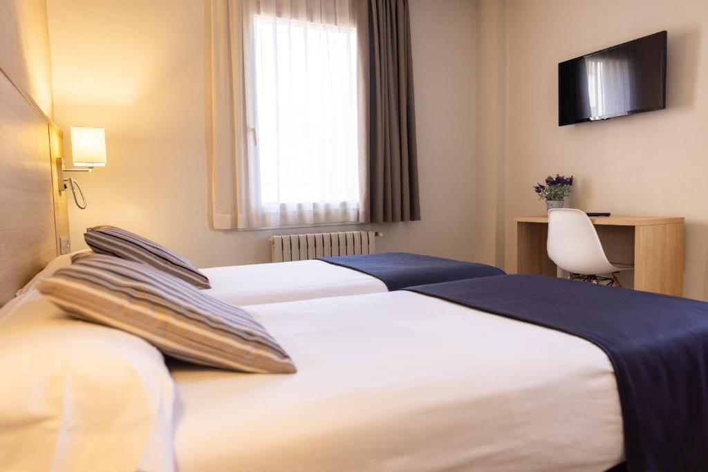Postel nebo postele na pokoji v ubytování Hotel Terminus