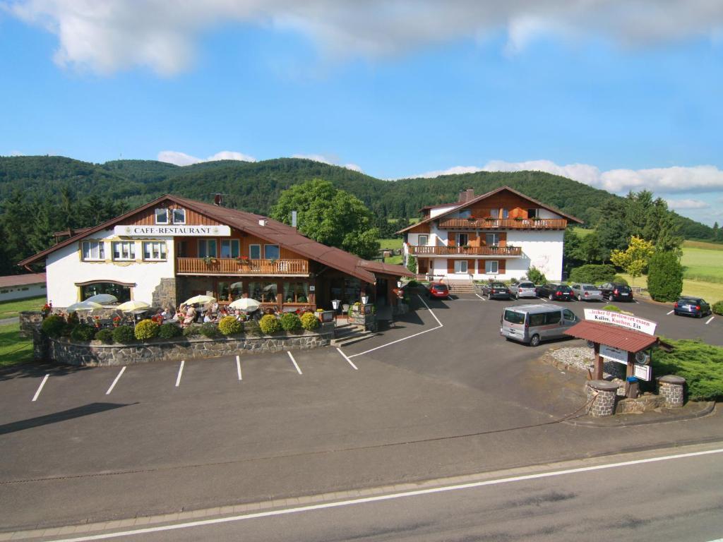 a parking lot in front of a hotel at Waldhotel Dornröschenshöh in Hemfurth-Edersee