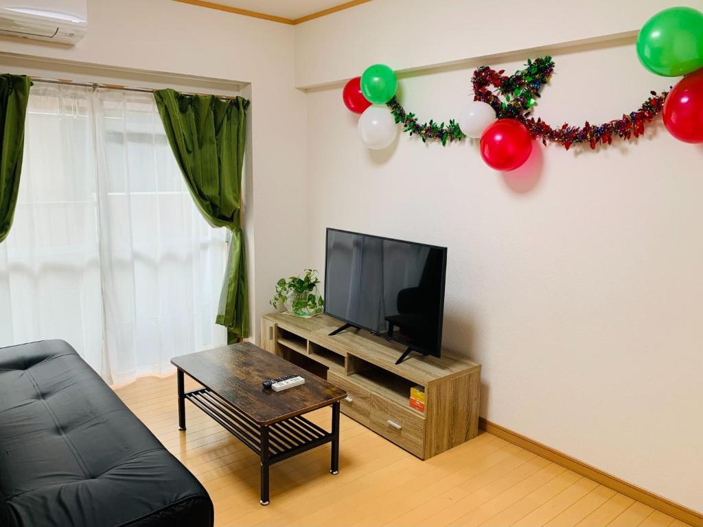 a living room with a flat screen tv and balloons at K&M Heights - Vacation STAY 20628v in Tokyo