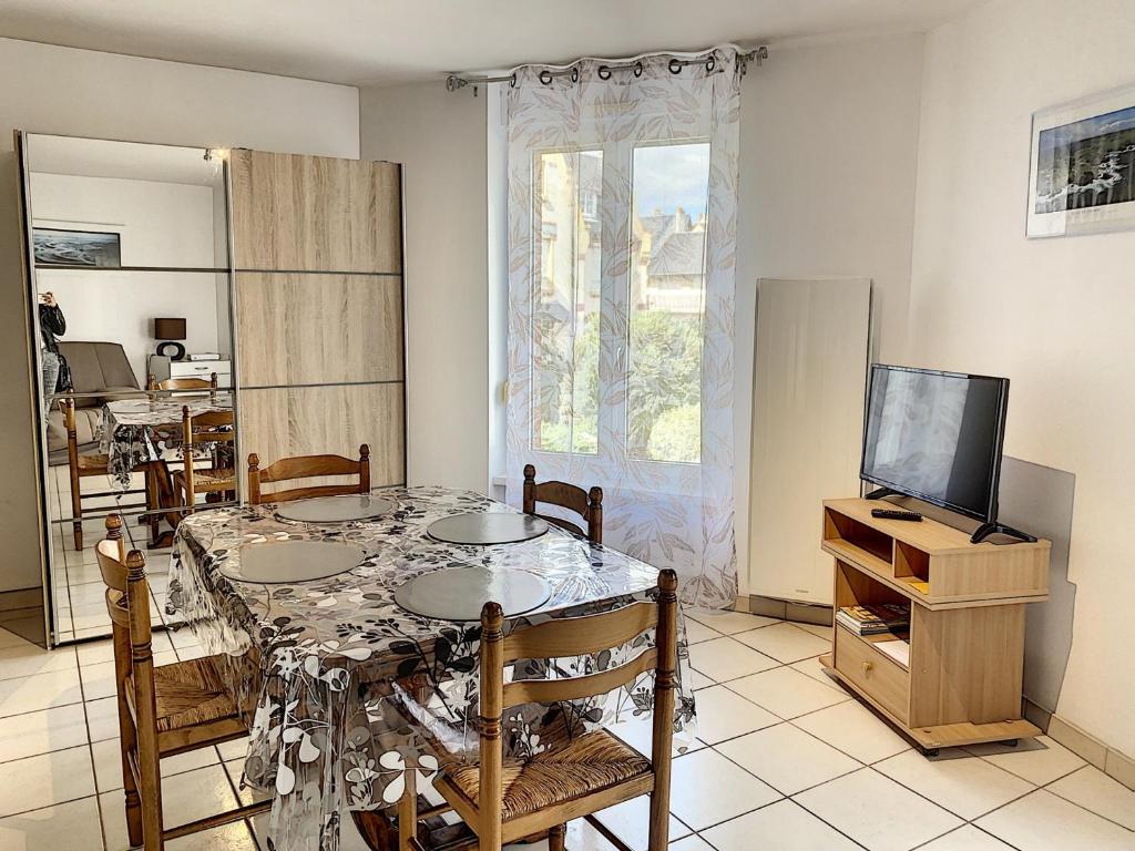 a dining room with a table and a television at Studio à deux pas de la plage, proche commerces avec Wifi et équipements complets - FR-1-361-40 in Saint-Pair-sur-Mer