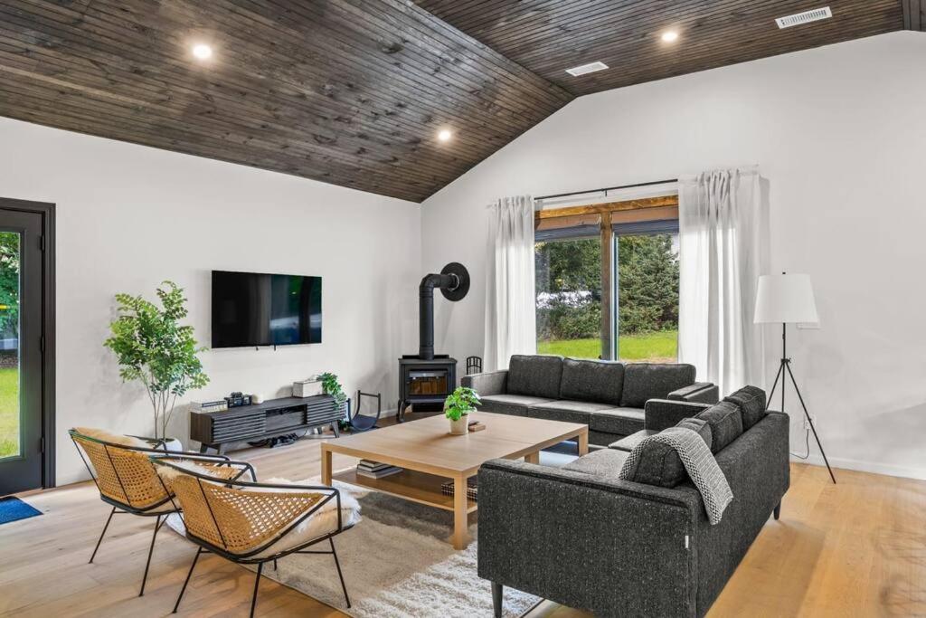 a living room with two couches and a table at Campfire Bungalow - Kid Friendly in Palenville