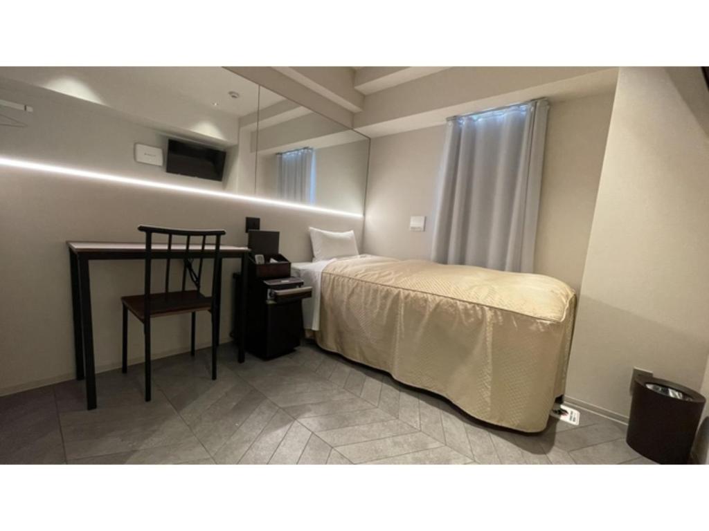 a bedroom with a bed and a desk with a chair at Hotel Wisteria NARA - Vacation STAY 99261v in Nara