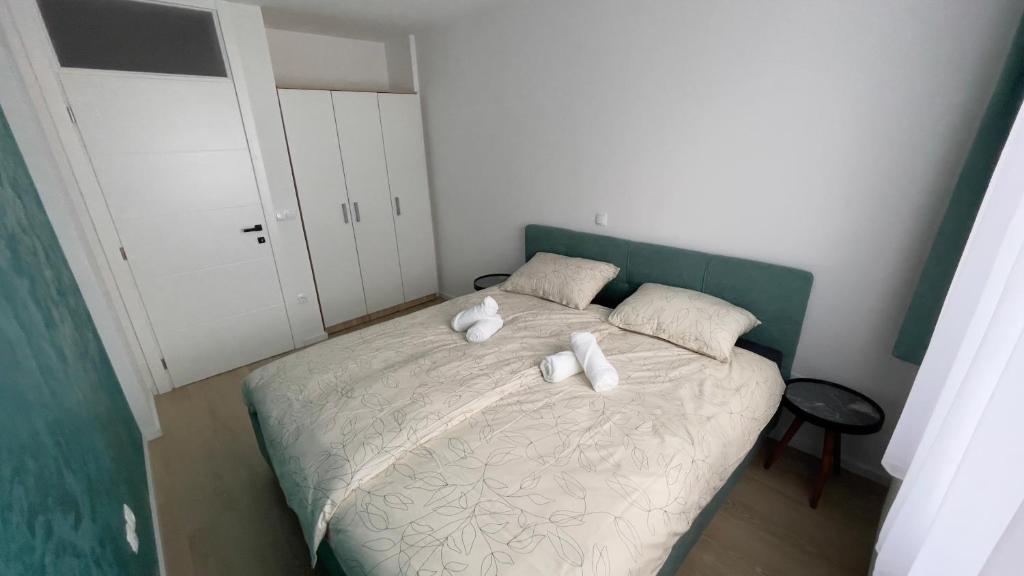 a small bedroom with a bed with two white pillows at Apartman Lux in Žepče