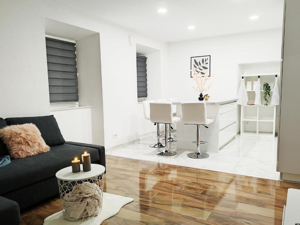 a living room with a couch and a table at Stara Pošta Apartment 8 in Grosuplje