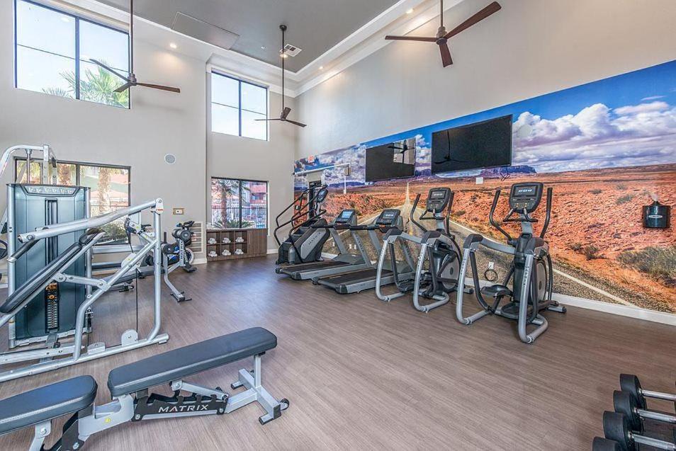 a gym with a row of exercise bikes and a wall with a mural at 1Bedroom Chic apartment in Phoenix