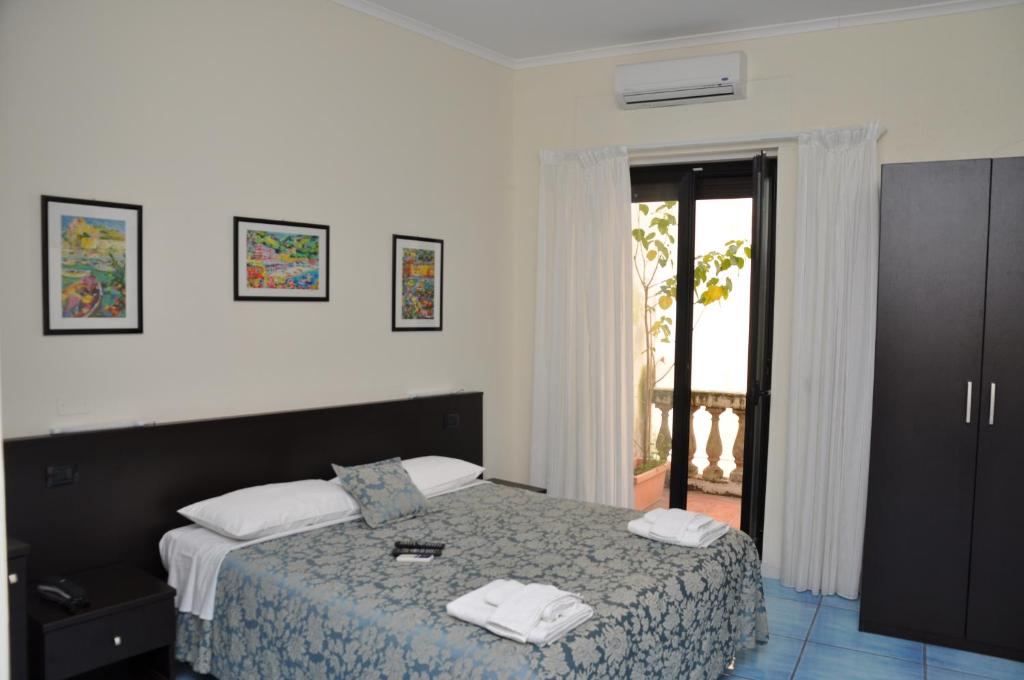 a bedroom with a bed with two towels on it at B&B Stella Maris in Diamante