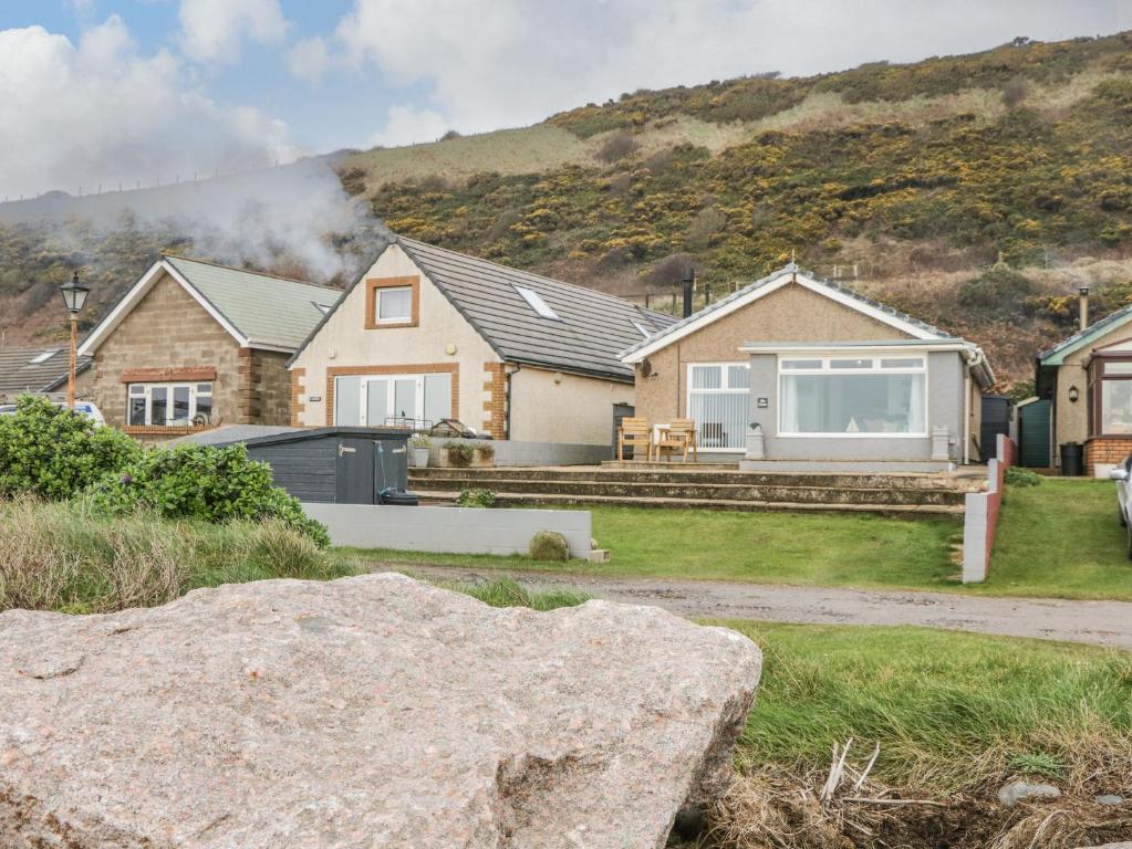 a house with a rock in the yard at The Chalet in Egremont