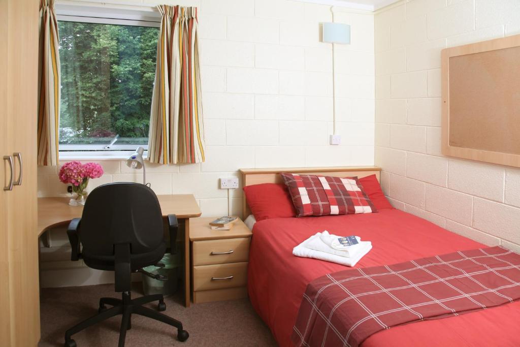 a bedroom with two beds and a desk and a desk at Castlewhite Apartments - UCC Summer Beds in Cork