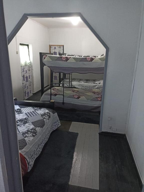 Una cama o camas en una habitación de Hostel INK - Duerme Como En Casa