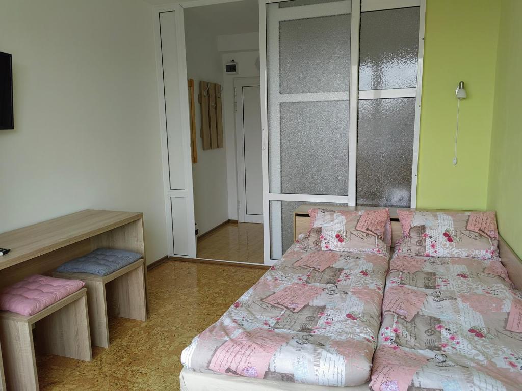 1 dormitorio con cama, mesa y escritorio en VikZ - Студио за гости Габрово център en Gabrovo