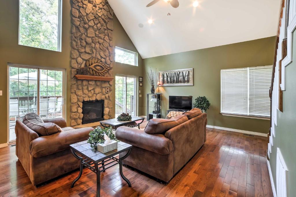 a living room with two couches and a fireplace at Hot Tub and Wooded Views Lakefront Blue Eye Cottage in Blue Eye