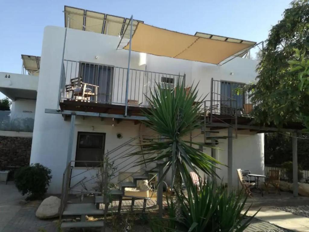 a house with a balcony and a patio at Desert Sunrise Arad in Arad