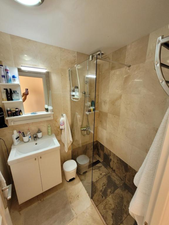 a bathroom with a sink and a shower at Apartament CALETA in Caleta De Fuste