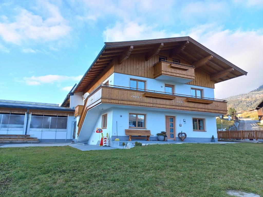 a house with a wooden roof at Ferienwohnung Kant in Fieberbrunn