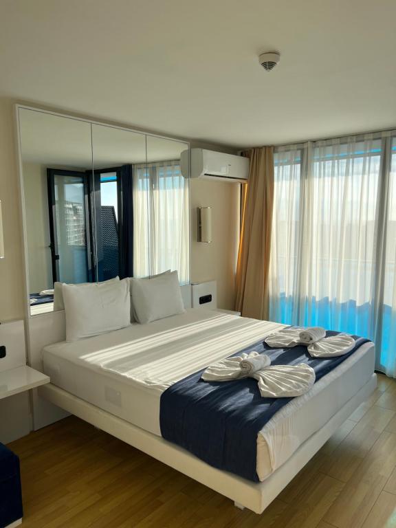 a bedroom with a large bed with a blue blanket at Batumi Rest Apartament in Batumi