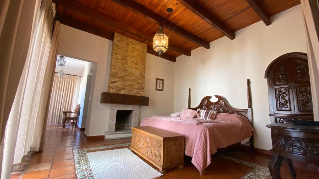 a bedroom with a bed and a fireplace at Casa Doña Elena in Bernal