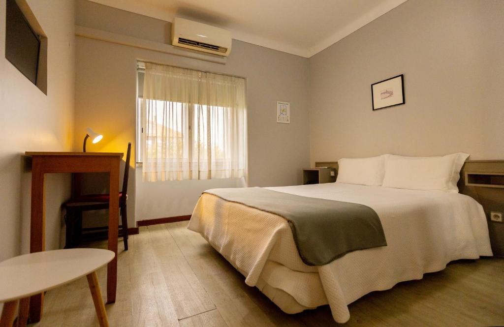 Postel nebo postele na pokoji v ubytování Hotel Sao Nicolau