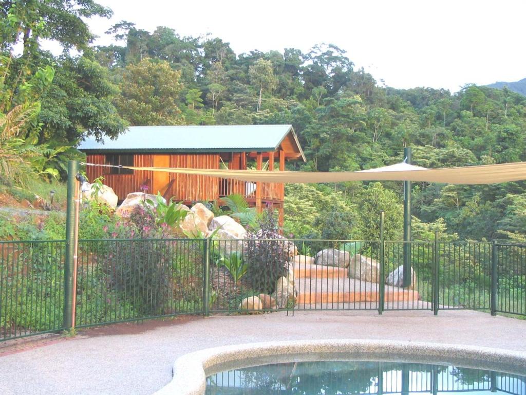 a fence with a pool in front of a house at Coral Sea Views in Diwan