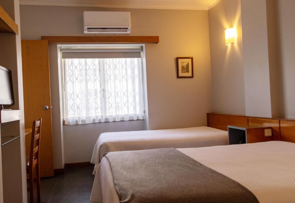 Postel nebo postele na pokoji v ubytování Hotel Sao Nicolau