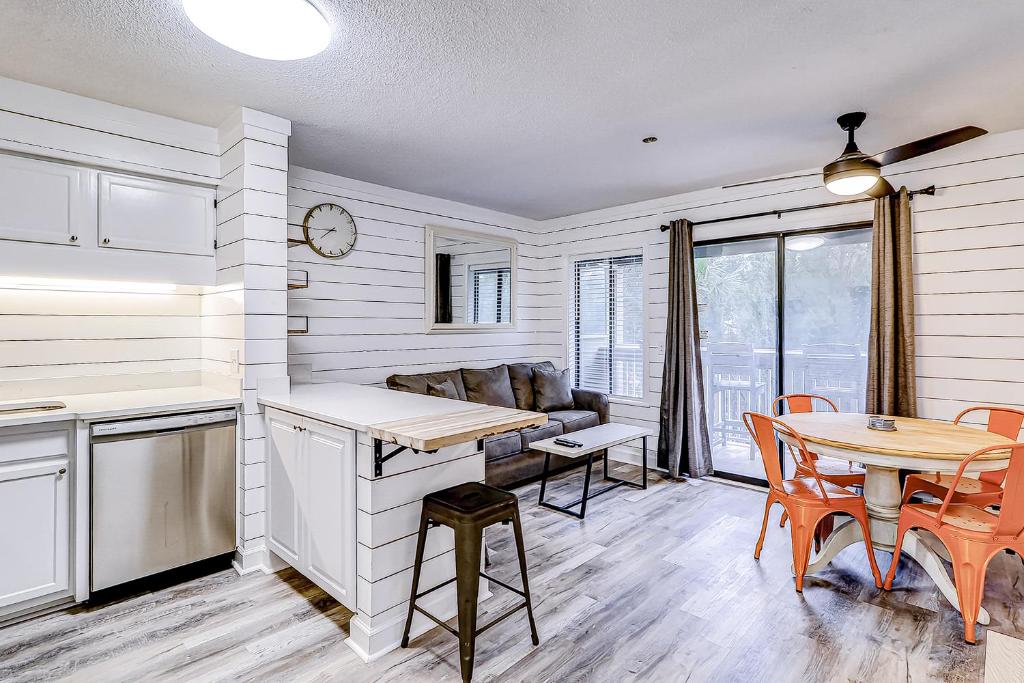 a kitchen and dining room with a table and chairs at Carolina Beach Club, Unit 126 in Hilton Head Island