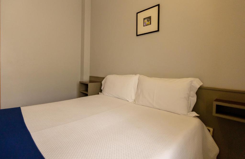 Postel nebo postele na pokoji v ubytování Hotel Sao Nicolau