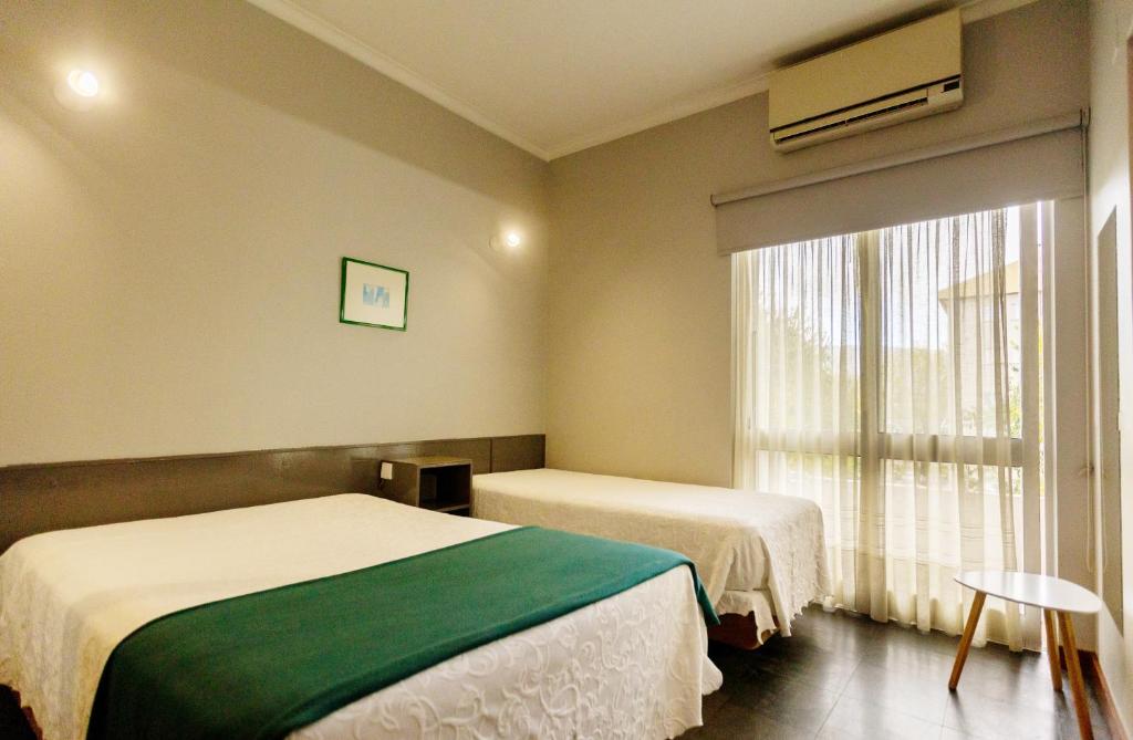 Postel nebo postele na pokoji v ubytování Hotel Sao Nicolau