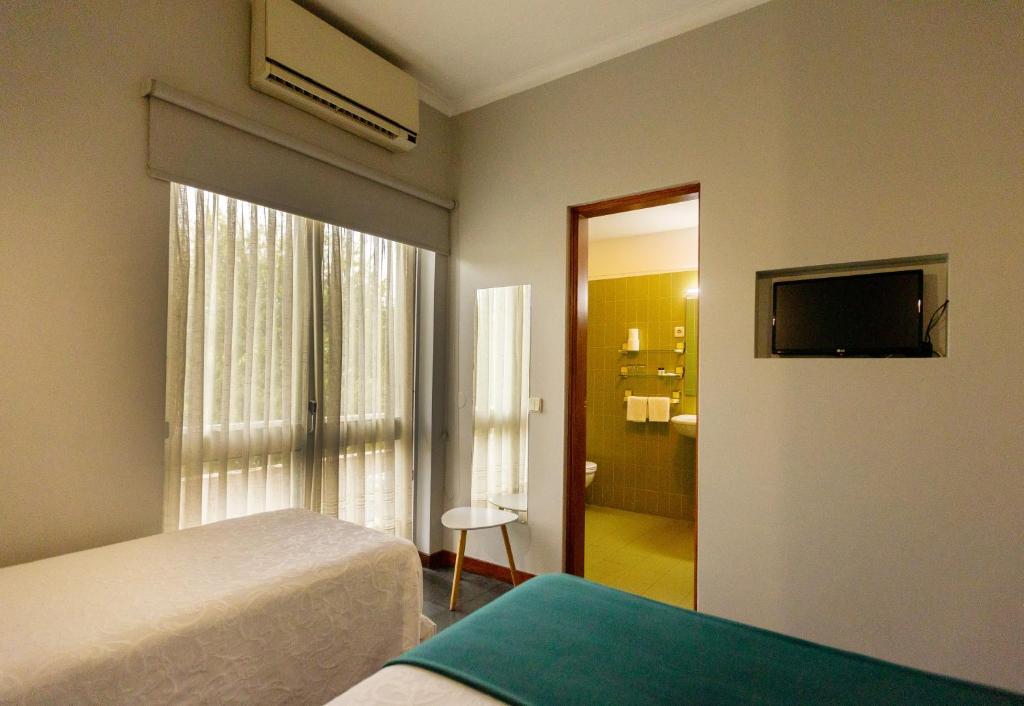 Postel nebo postele na pokoji v ubytování Hotel Sao Nicolau