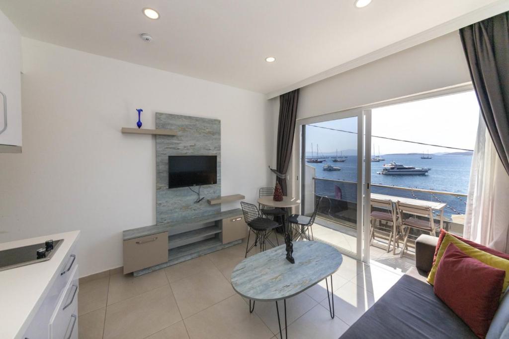 a living room with a view of the ocean at Seafront Flat with Excellent Sea View in Bodrum in Bodrum City