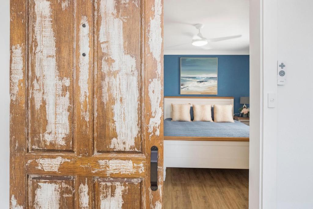 a door leading into a bedroom with a bed at BJ Mick's Lakefront Apartment in Forster