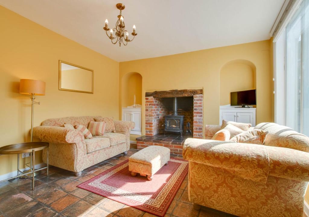 a living room with two couches and a fireplace at 4 Lambseth Street in Eye