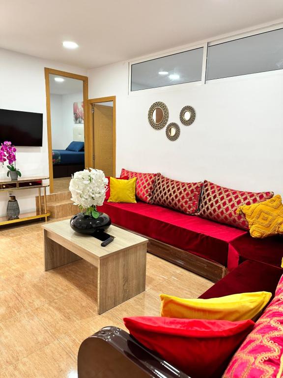 a living room with a red couch and a table at Apartment en Rambla in Alicante