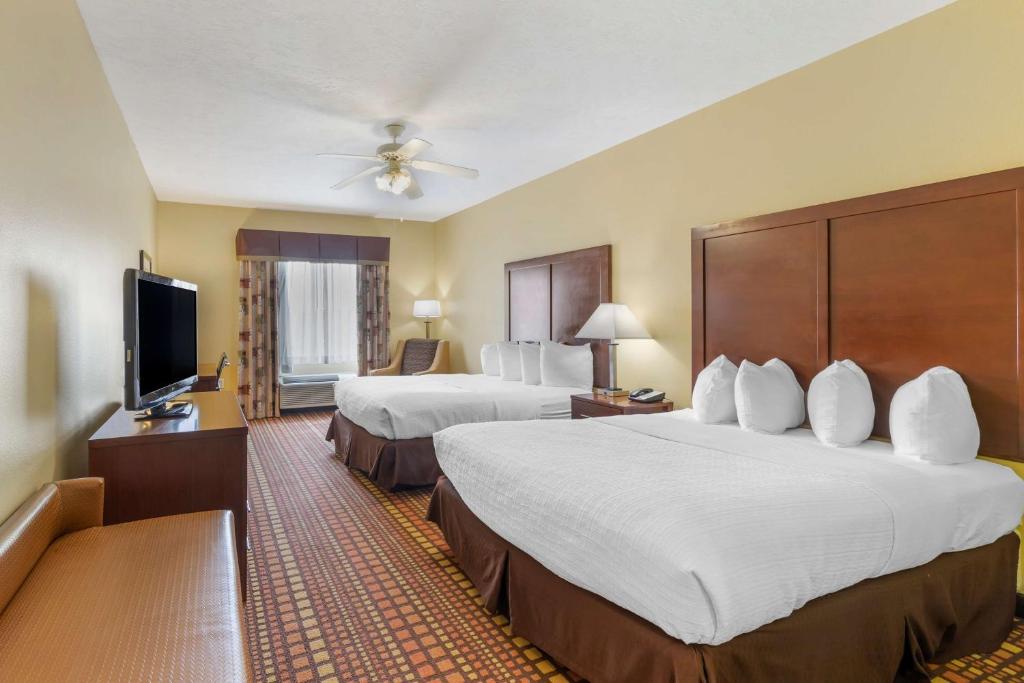 a hotel room with two beds and a flat screen tv at Best Western Plus Gadsden Hotel & Suites in Gadsden
